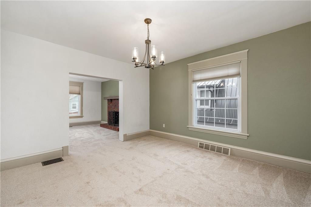 313 Oak Street Butler, PA 16001 - Photo 7 of 23 an empty room with chandelier and windows