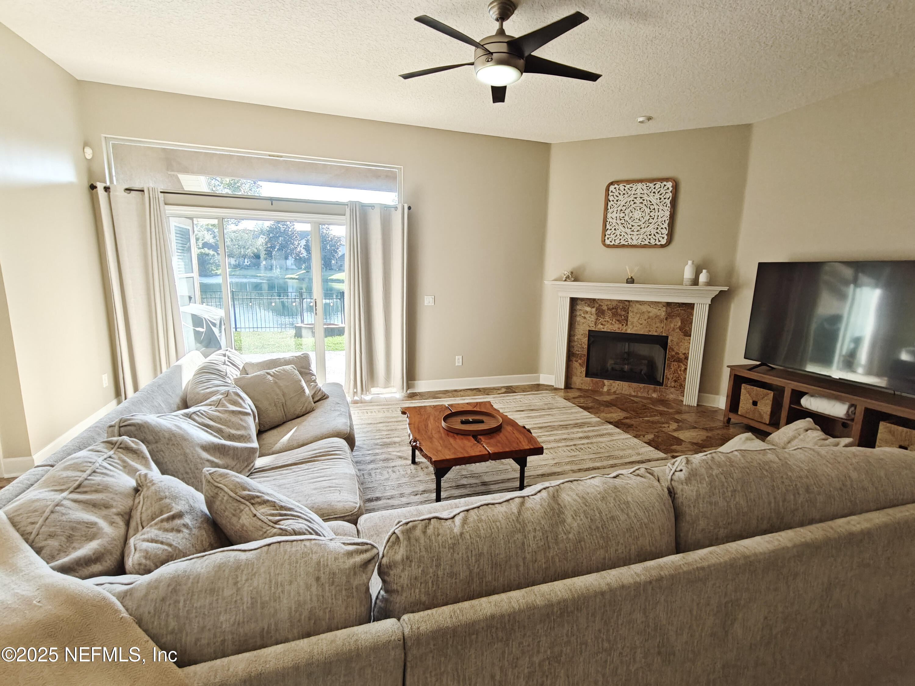 1505 Majestic View Lane Fleming Island, FL 32003 - Photo 11 of 49 a living room with furniture and a fireplace