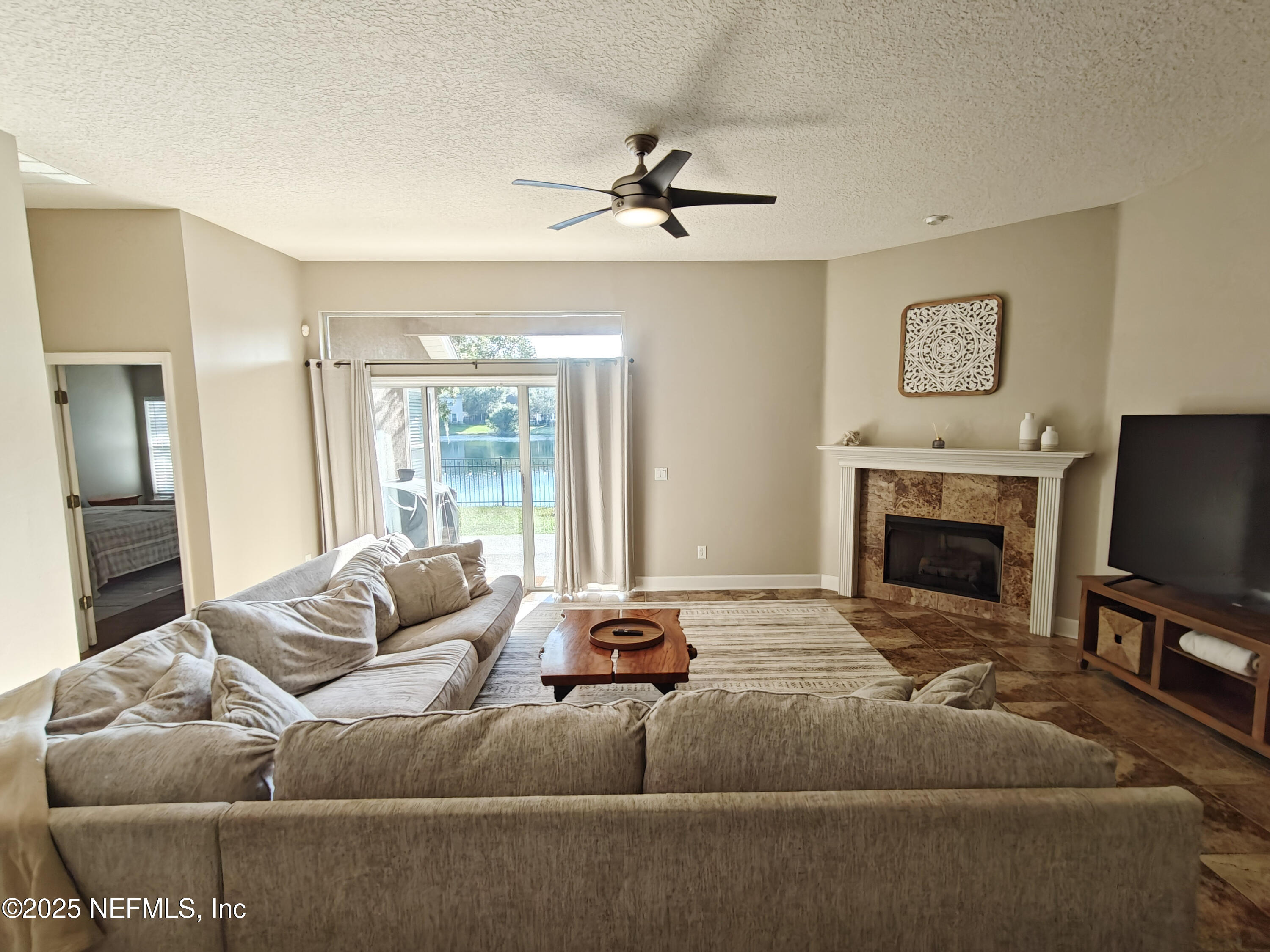 1505 Majestic View Lane Fleming Island, FL 32003 - Photo 12 of 49 a living room with furniture a flat screen tv and a fireplace