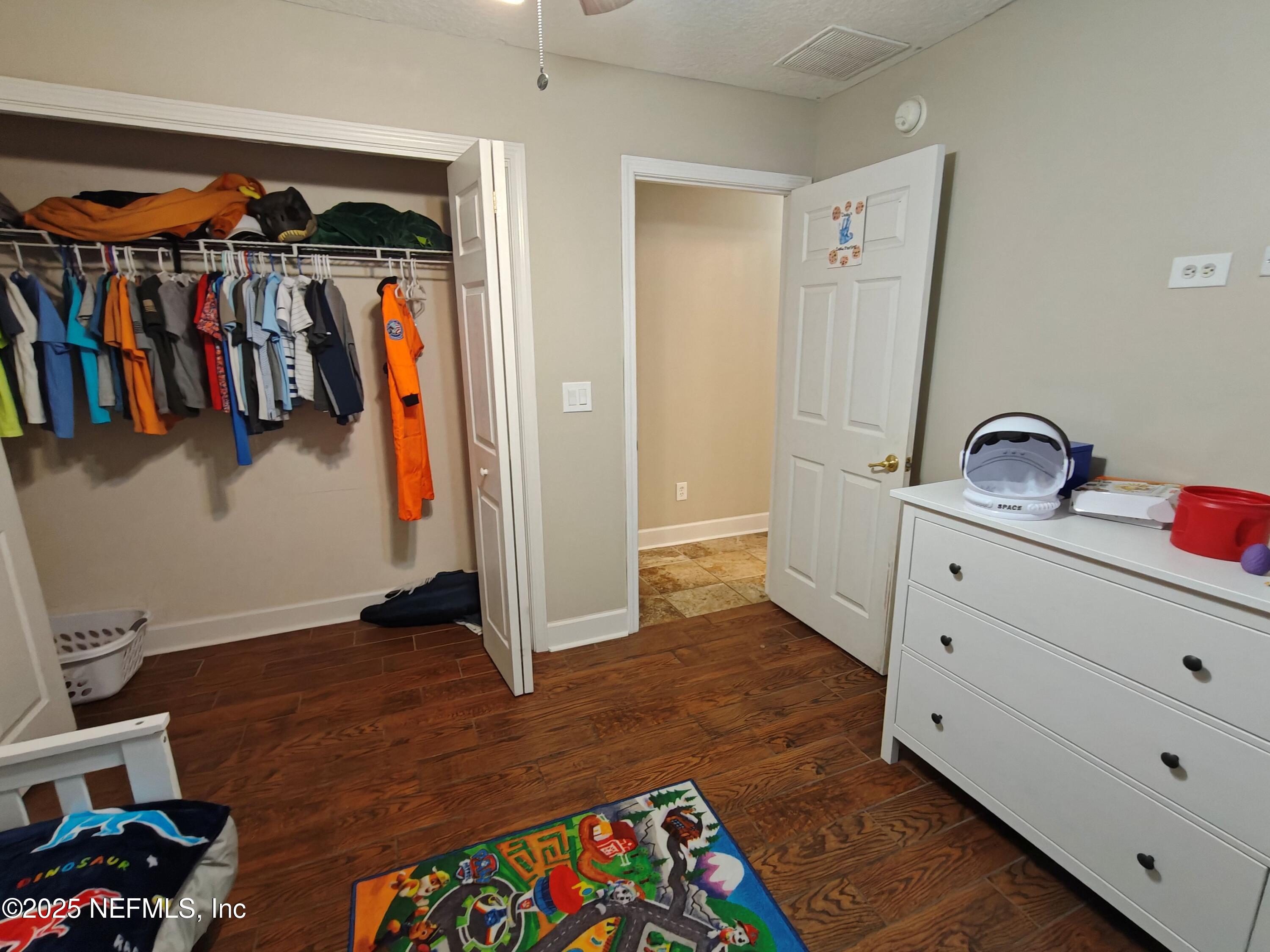 1505 Majestic View Lane Fleming Island, FL 32003 - Photo 24 of 49 a view of walk in closet with clothes and shoes