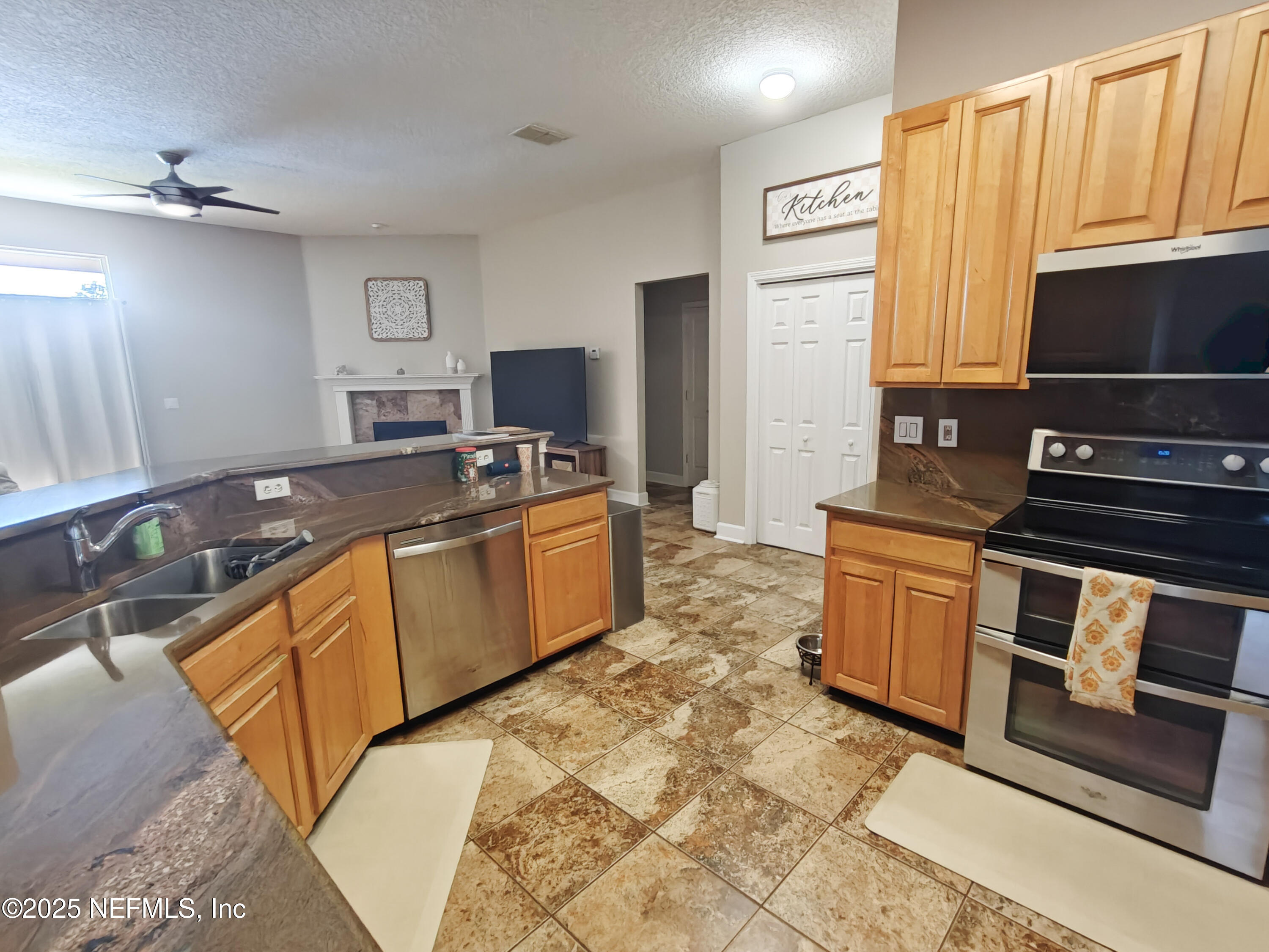 1505 Majestic View Lane Fleming Island, FL 32003 - Photo 7 of 49 a kitchen with stainless steel appliances granite countertop a stove a sink and a microwave