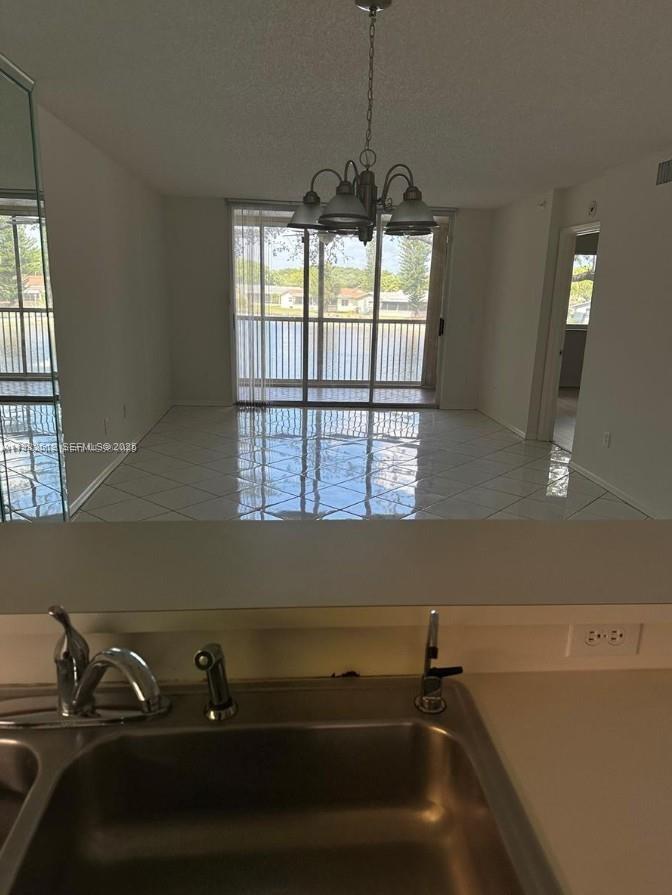 9587 Weldon Circle, Unit B203 Tamarac, FL 33321 - Photo 11 of 22 a view of a room with windows and chandelier