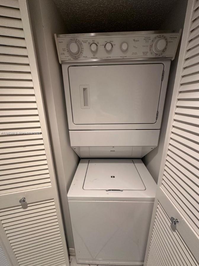 9587 Weldon Circle, Unit B203 Tamarac, FL 33321 - Photo 13 of 22 a utility room with dryer and washer