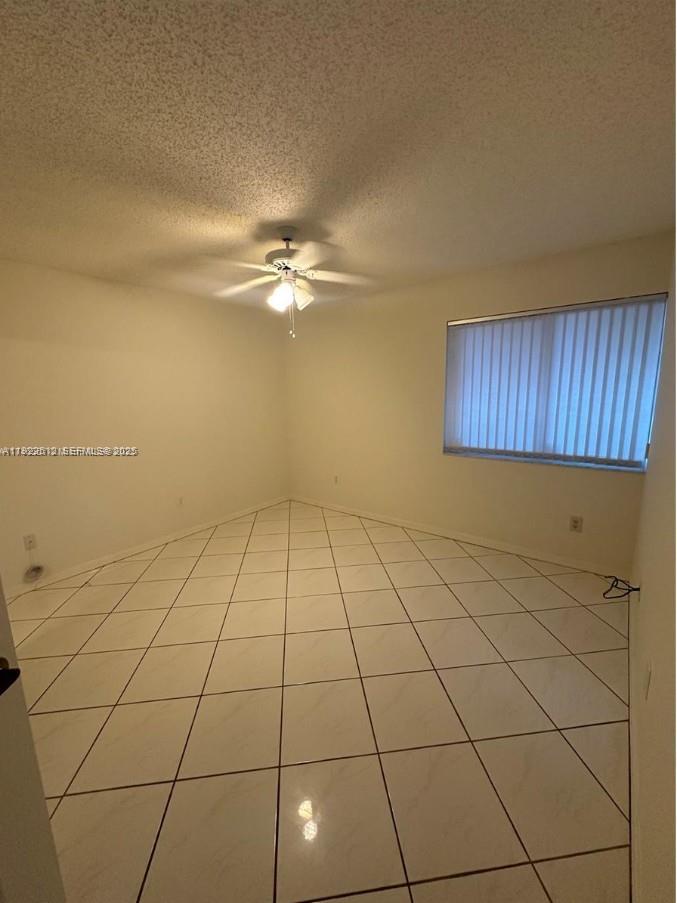 9587 Weldon Circle, Unit B203 Tamarac, FL 33321 - Photo 15 of 22 a view of a kitchen with an empty space and a sink