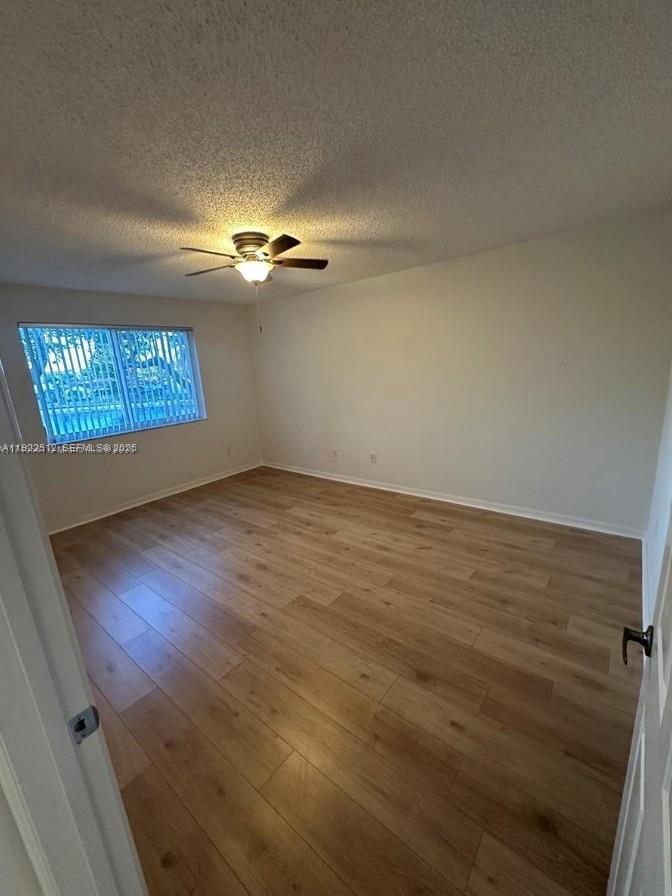 9587 Weldon Circle, Unit B203 Tamarac, FL 33321 - Photo 17 of 22 a view of an empty room with a window