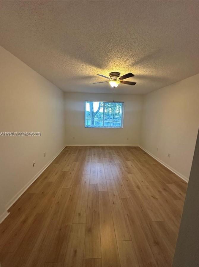9587 Weldon Circle, Unit B203 Tamarac, FL 33321 - Photo 18 of 22 wooden floor in an empty room