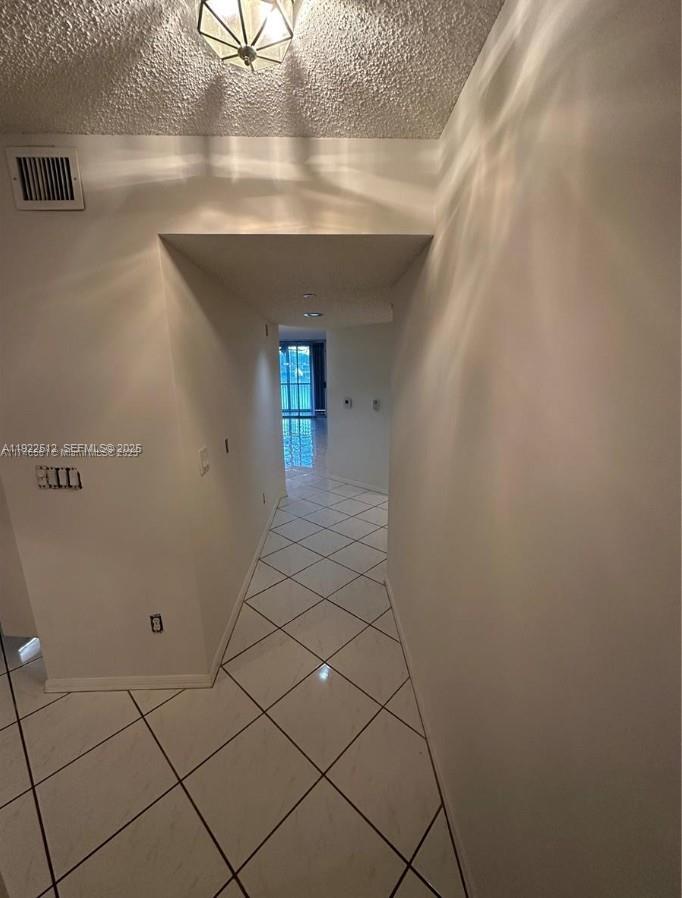 9587 Weldon Circle, Unit B203 Tamarac, FL 33321 - Photo 3 of 22 a view of a livingroom with an empty space and a window