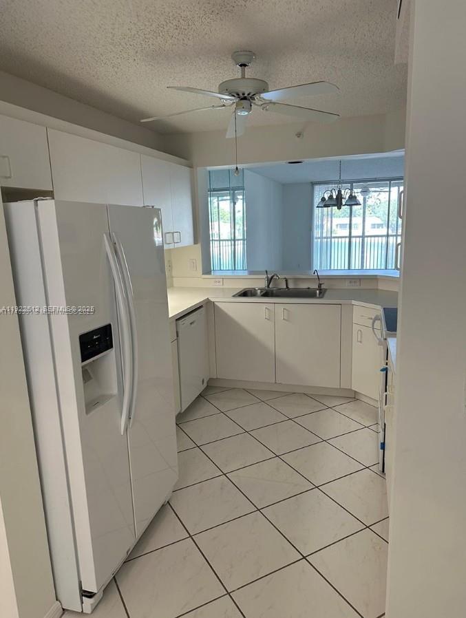 9587 Weldon Circle, Unit B203 Tamarac, FL 33321 - Photo 6 of 22 a kitchen with stainless steel appliances a refrigerator sink and cabinets