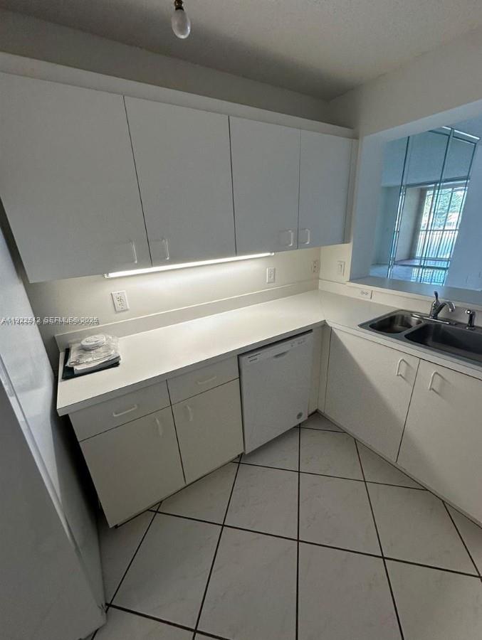 9587 Weldon Circle, Unit B203 Tamarac, FL 33321 - Photo 8 of 22 a kitchen with a sink cabinets and appliances