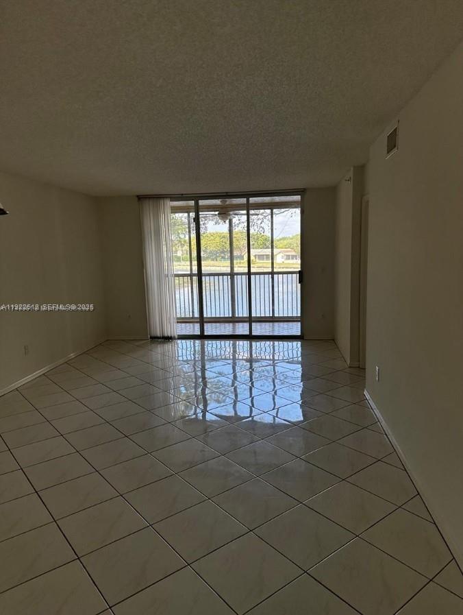 9587 Weldon Circle, Unit B203 Tamarac, FL 33321 - Photo 9 of 22 an empty room with windows