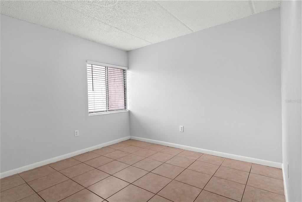 1108 Bartow Road, Unit 100 Lakeland, FL 33801 - Photo 15 of 15 wooden floor in an empty room with a window