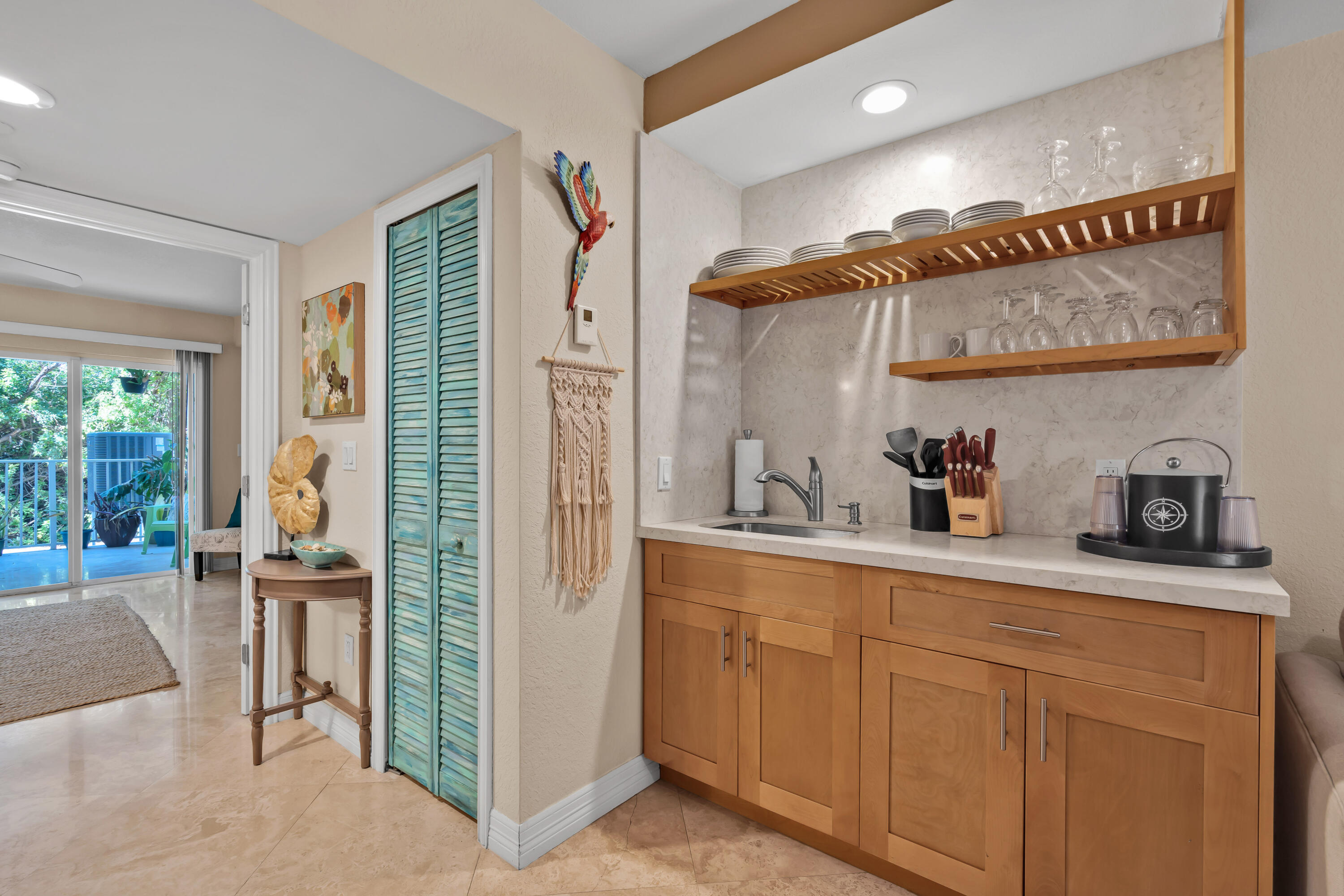 97501 Overseas Highway, Unit 607 Key Largo, FL 33037 - Photo 20 of 73 a kitchen with white cabinets and counter space