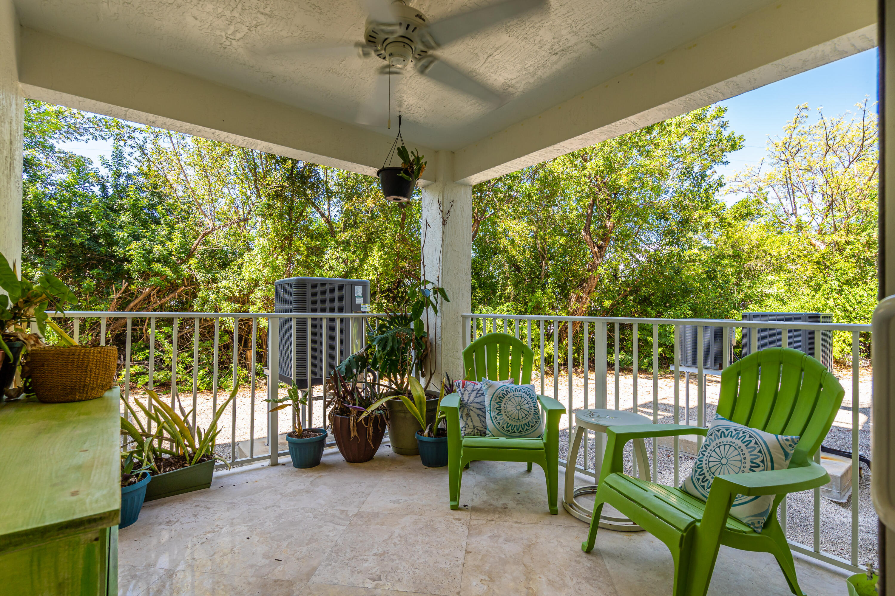 97501 Overseas Highway, Unit 607 Key Largo, FL 33037 - Photo 22 of 73 a view of a chairs and table in patio