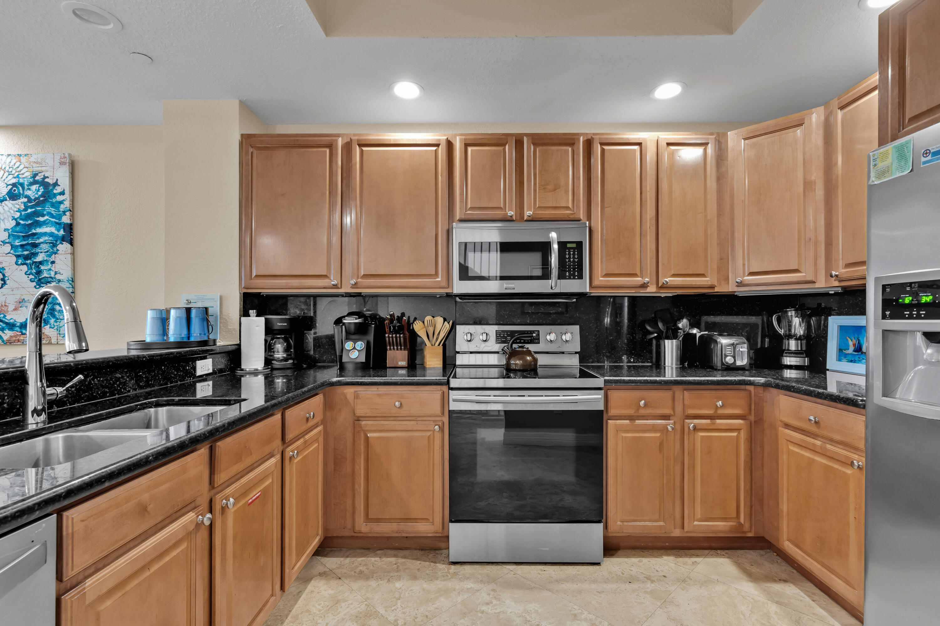 97501 Overseas Highway, Unit 607 Key Largo, FL 33037 - Photo 32 of 73 a kitchen with stainless steel appliances granite countertop a stove sink microwave and cabinets