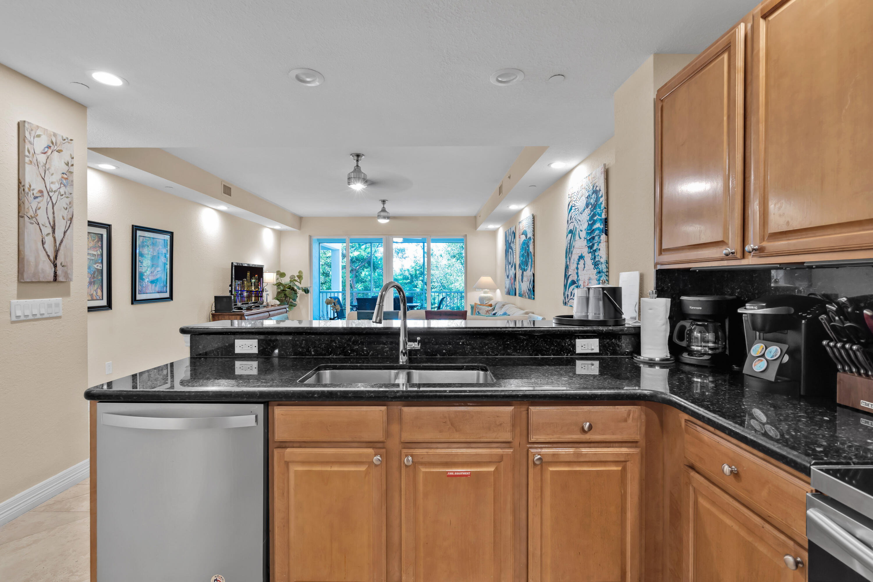 97501 Overseas Highway, Unit 607 Key Largo, FL 33037 - Photo 33 of 73 a kitchen with granite countertop a sink a counter top space and cabinets