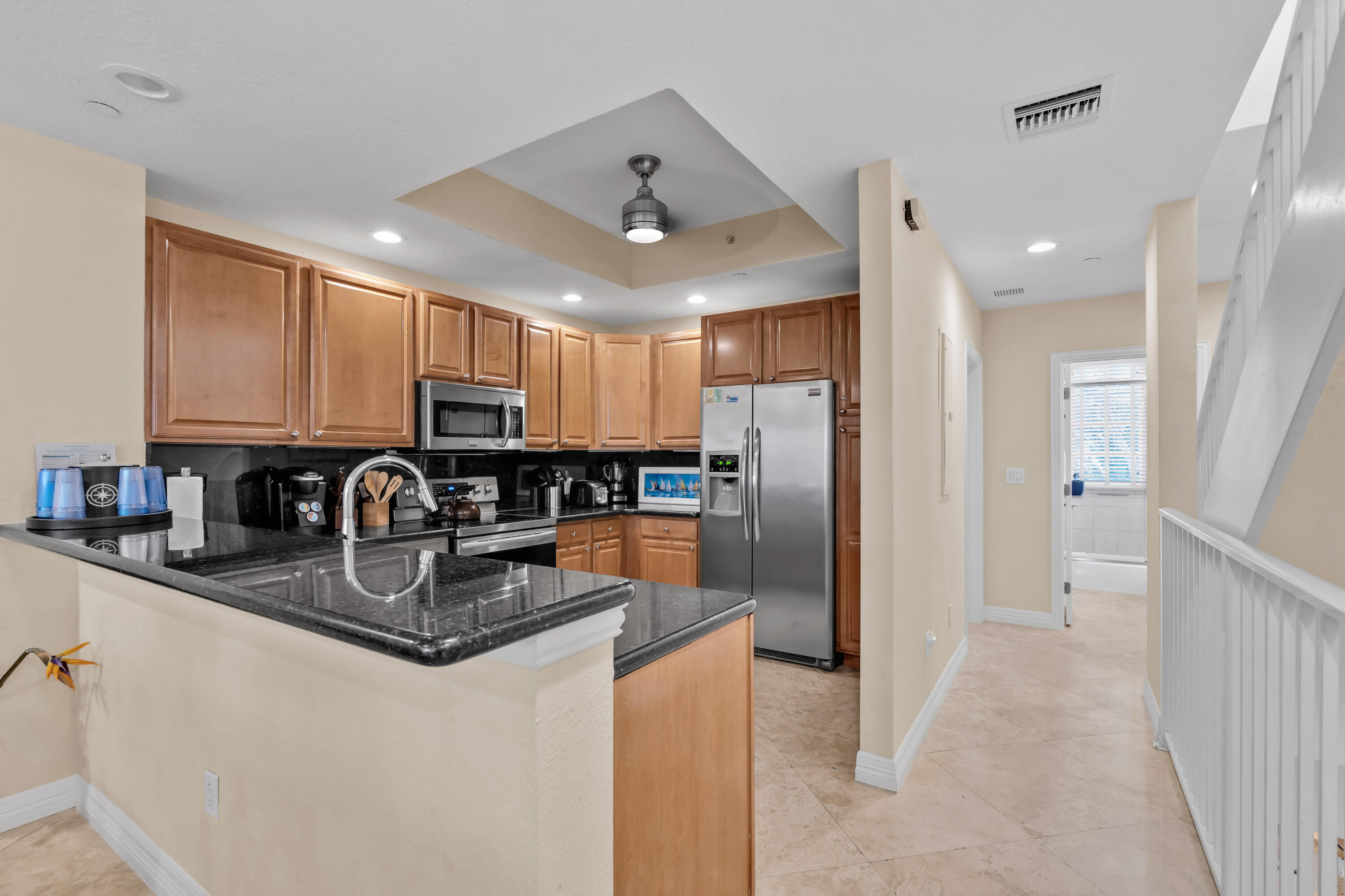 97501 Overseas Highway, Unit 607 Key Largo, FL 33037 - Photo 34 of 73 a kitchen with stainless steel appliances granite countertop a refrigerator a sink a stove a microwave and island