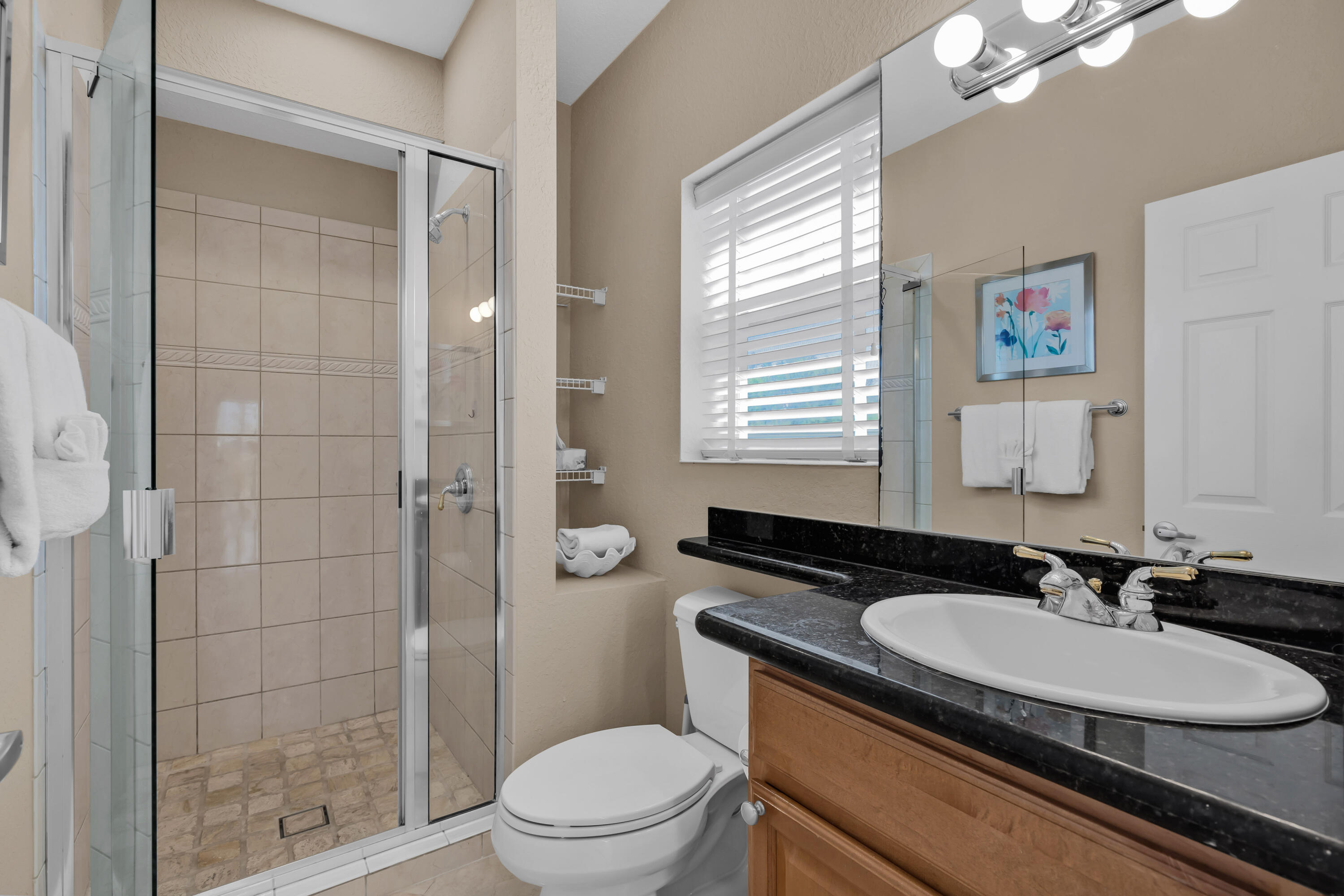 97501 Overseas Highway, Unit 607 Key Largo, FL 33037 - Photo 42 of 73 a bathroom with a sink a toilet a mirror and a shower