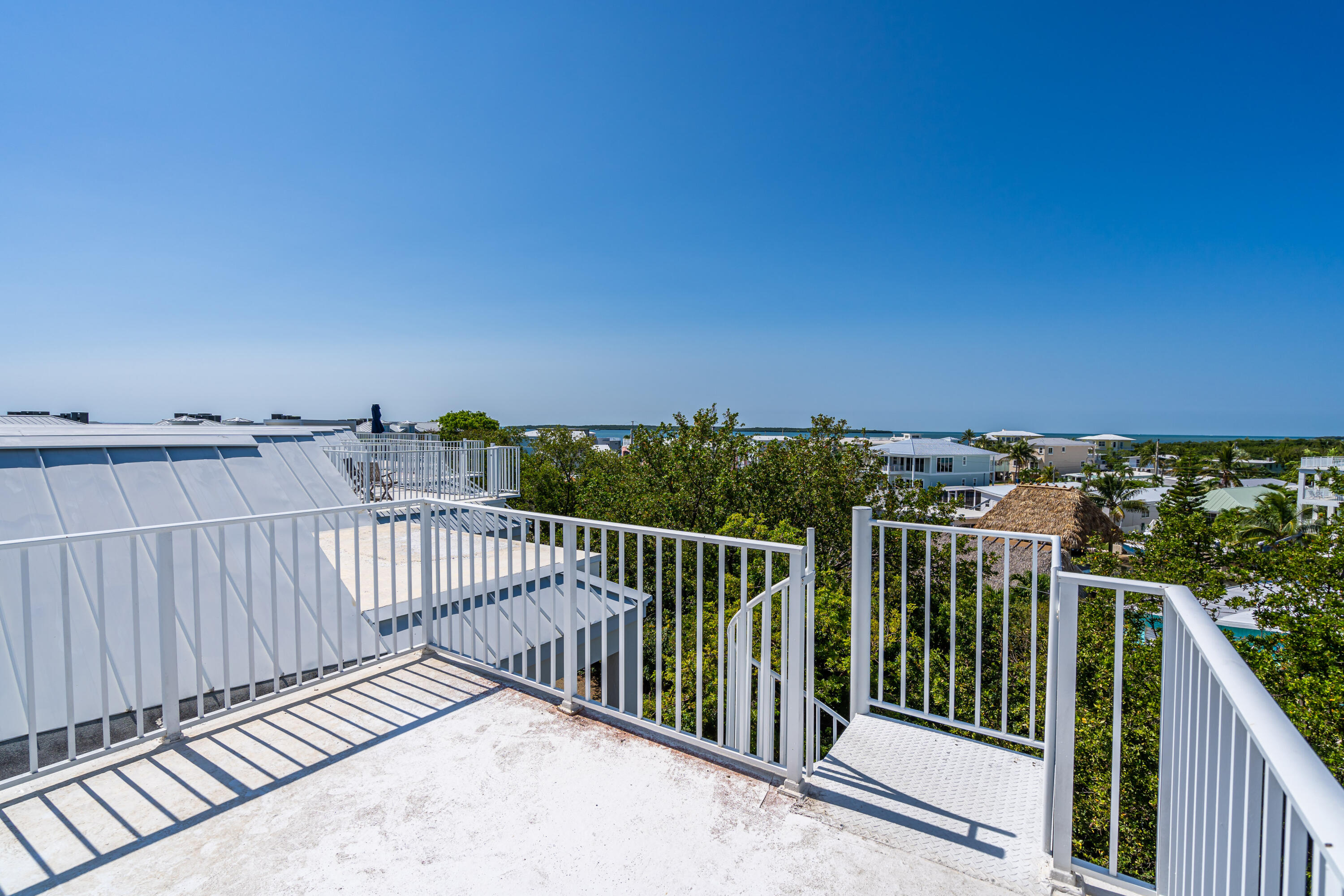 97501 Overseas Highway, Unit 607 Key Largo, FL 33037 - Photo 46 of 73 a view of balcony with wooden floor and fence