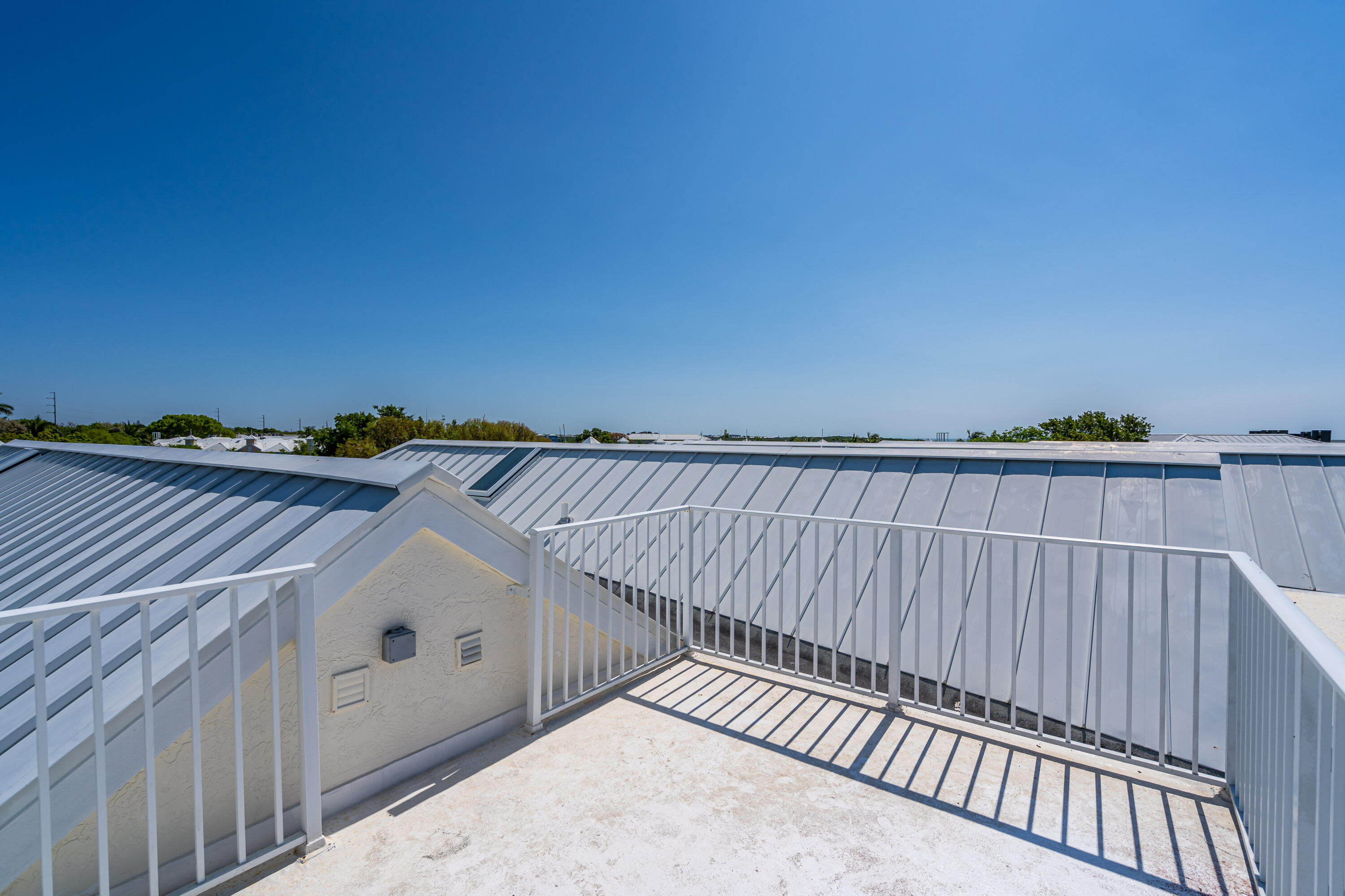 97501 Overseas Highway, Unit 607 Key Largo, FL 33037 - Photo 47 of 73 a view of balcony with wooden floor and fence