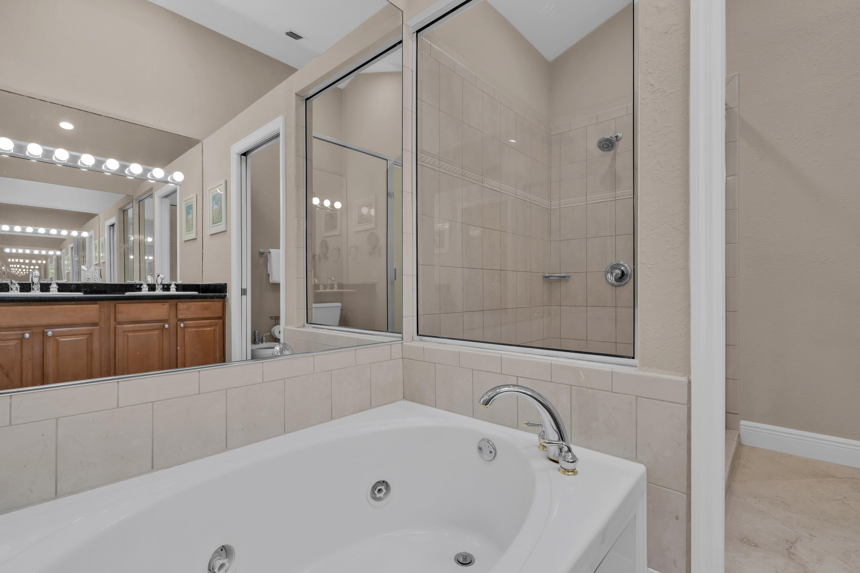 97501 Overseas Highway, Unit 607 Key Largo, FL 33037 - Photo 52 of 73 a bathroom with a tub a sink and a large mirror