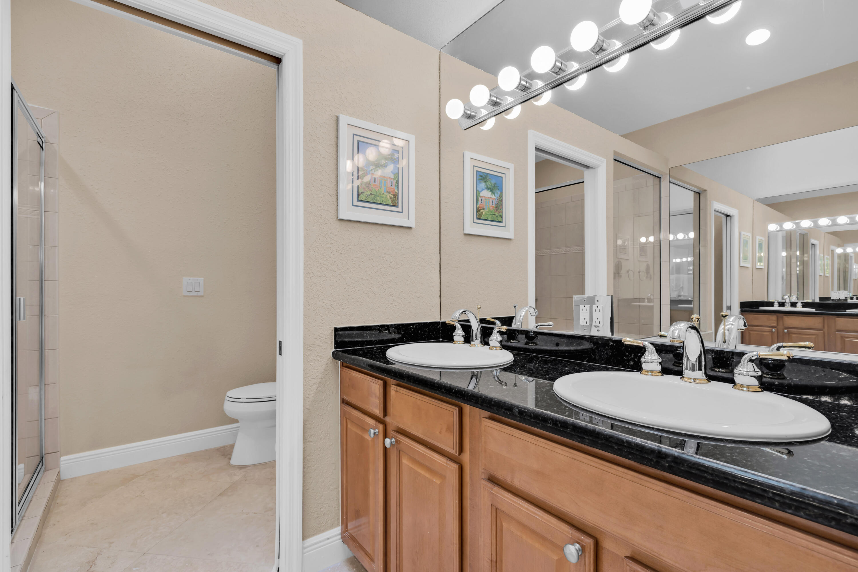 97501 Overseas Highway, Unit 607 Key Largo, FL 33037 - Photo 54 of 73 a bathroom with a granite countertop sink a toilet a mirror and shower