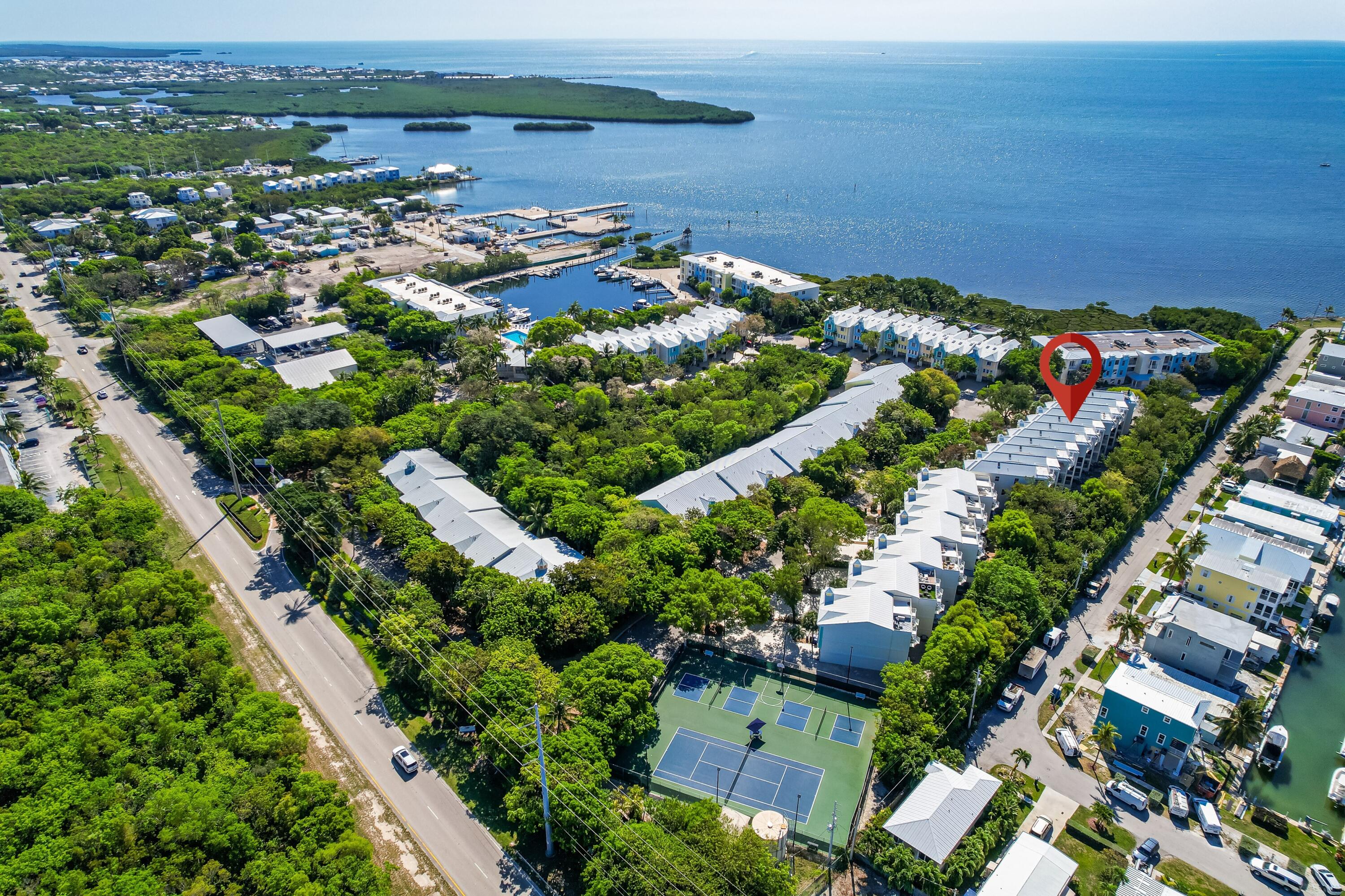 97501 Overseas Highway, Unit 607 Key Largo, FL 33037 - Photo 56 of 73 an aerial view of a residential houses with outdoor space and trees