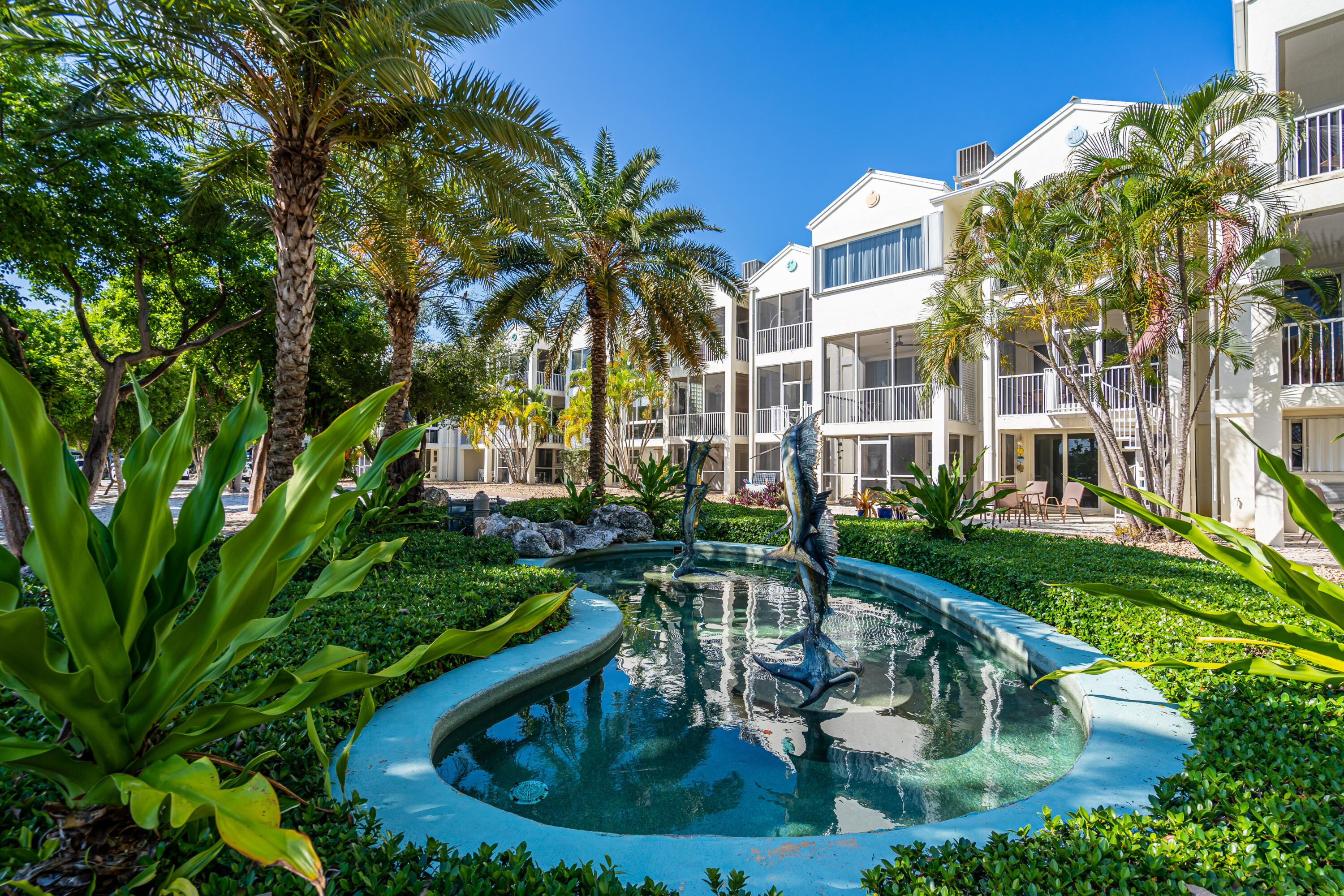 97501 Overseas Highway, Unit 607 Key Largo, FL 33037 - Photo 58 of 73 a swimming pool with outdoor seating and yard