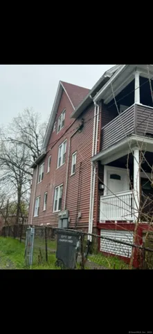 a view of backyard of house with a yard
