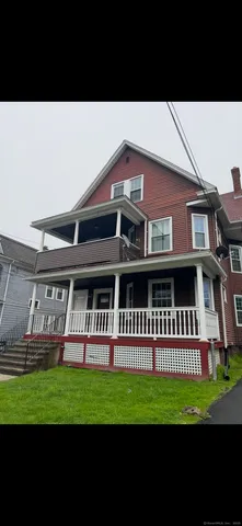a view of a house with a backyard and deck