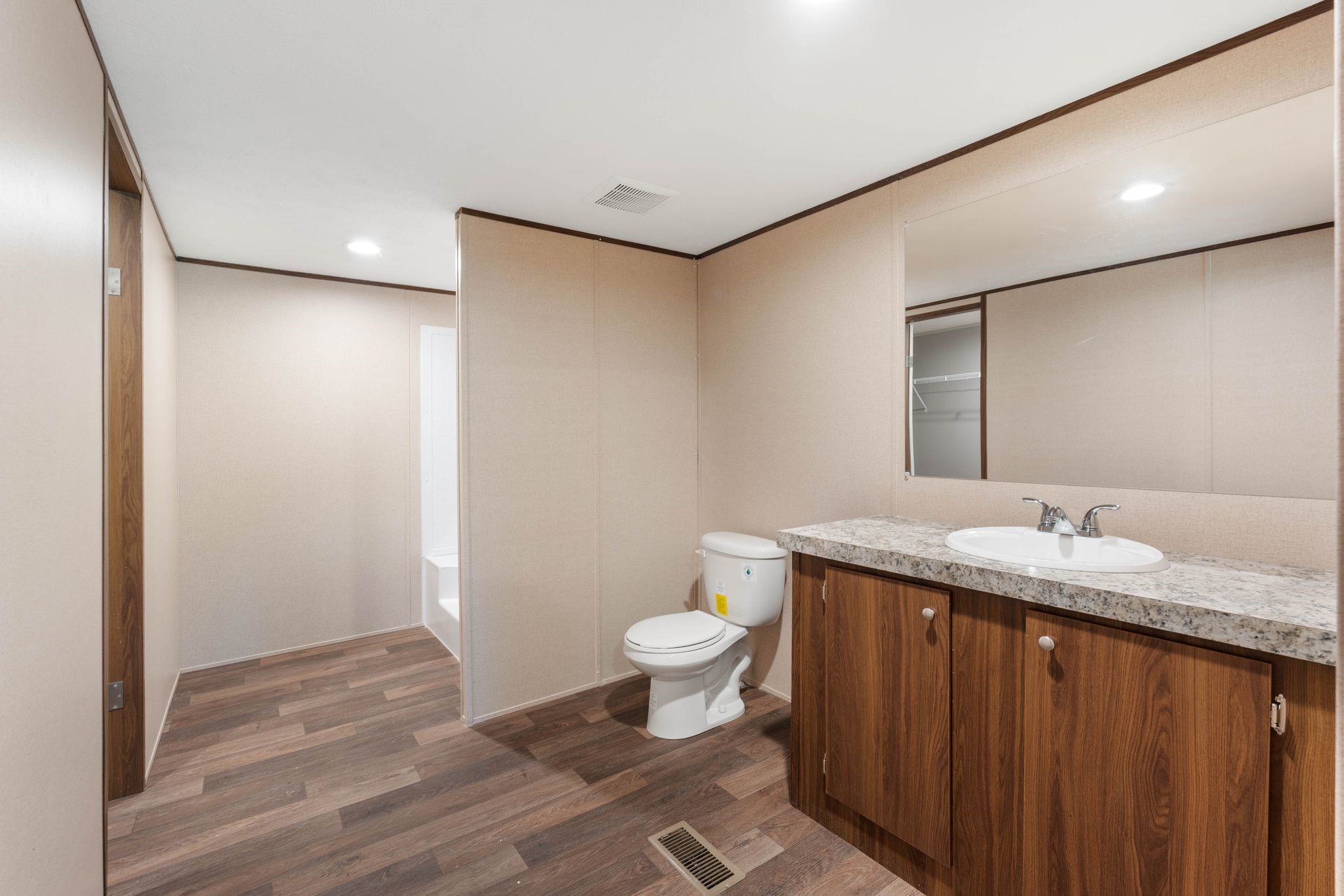 3941 Highline Oaks West Conroe, TX 77306 - Photo 16 of 38 a bathroom with a granite countertop sink a toilet and a mirror
