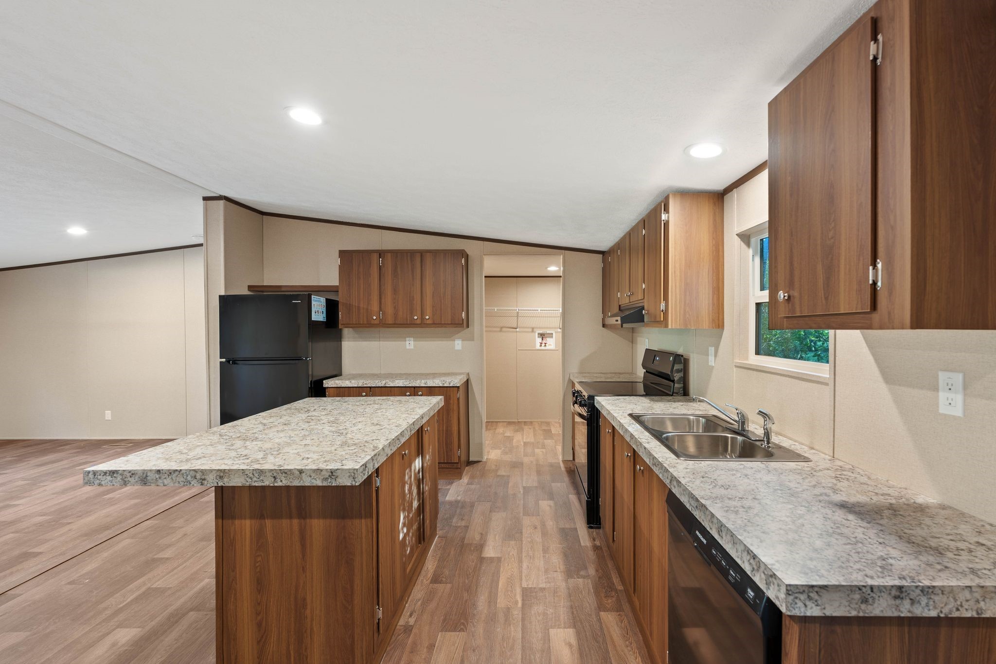 3941 Highline Oaks West Conroe, TX 77306 - Photo 9 of 38 a kitchen with stainless steel appliances granite countertop wooden cabinets sink and wooden floor