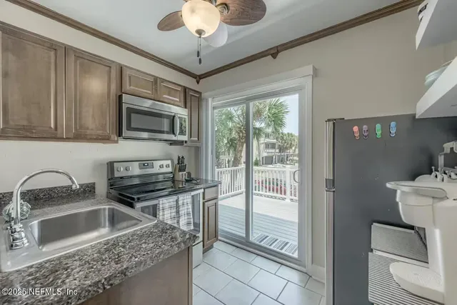 a kitchen with stainless steel appliances granite countertop a sink stove and microwave