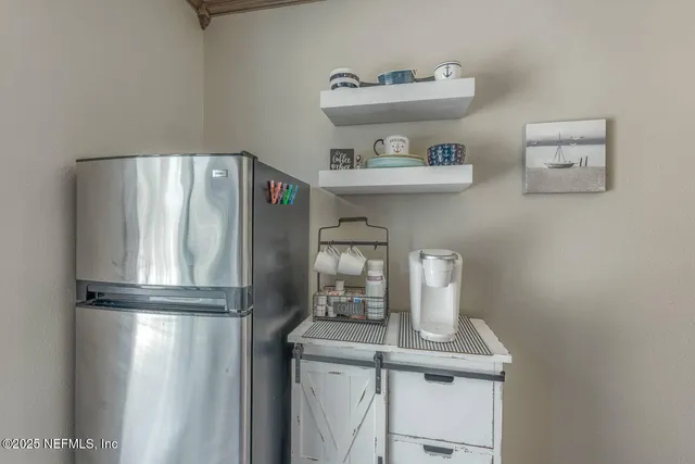 a bedroom with a bed and a window with a chandelier