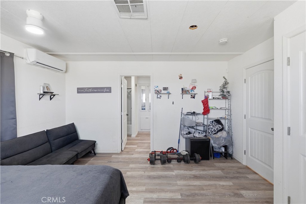 5885 Dos Palmas Road Phelan, CA 92371 - Photo 24 of 40 a bedroom with furniture and a closet