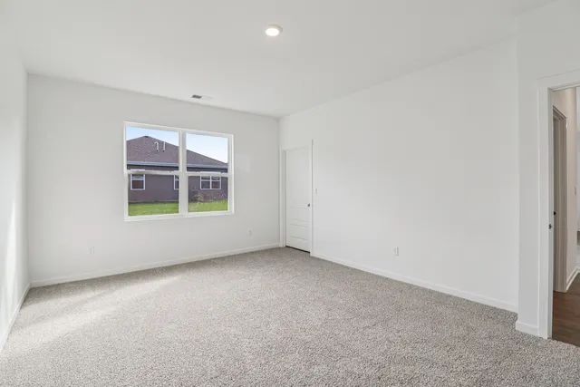 a view of an empty room and a window