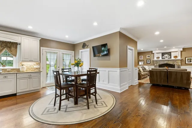 a view of a dining room with furniture and wooden floor