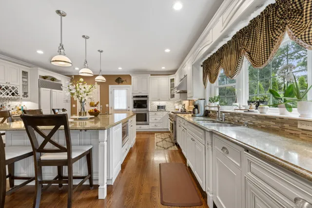 a large kitchen with lots of counter space and windows
