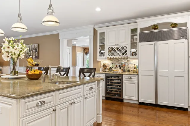 a kitchen with stainless steel appliances granite countertop a refrigerator sink and cabinets