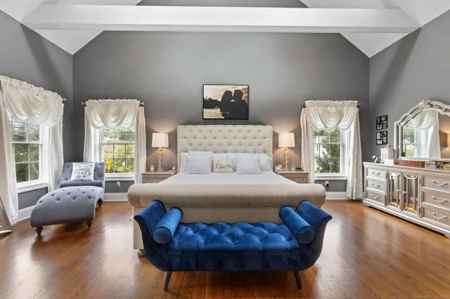 a bedroom with furniture and wooden floor