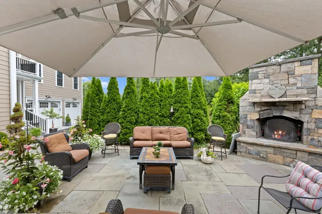 a outdoor living space with furniture and a fireplace