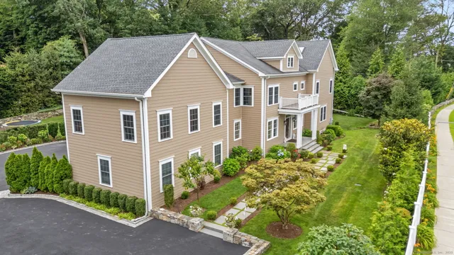 a view of a house with brick walls and a garden