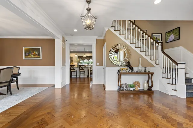 a view of entryway and hall with wooden floor