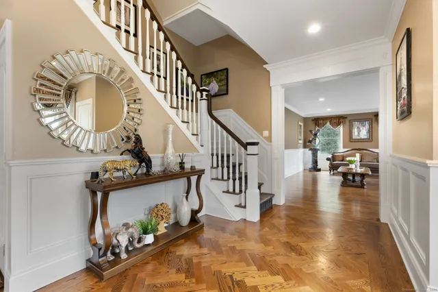 a view of entryway livingroom and hall with wooden floor