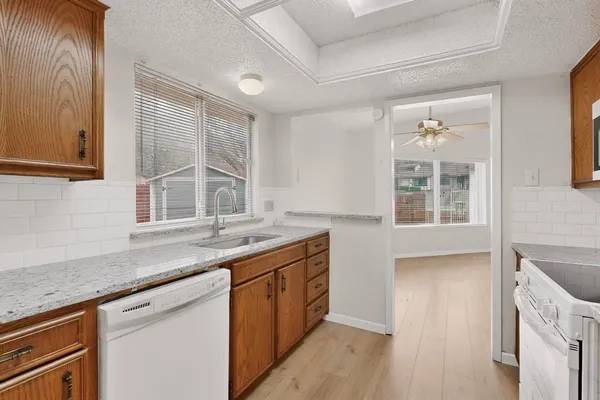 a kitchen with granite countertop a sink and a window