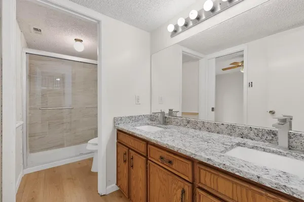 a bathroom with a granite countertop sink mirror and double