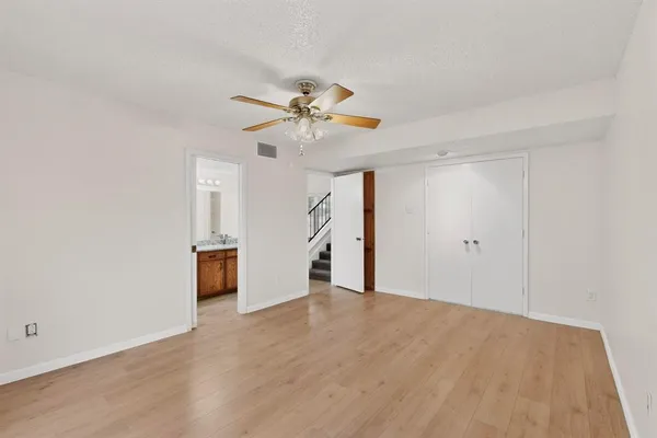 a view of an empty room with a ceiling fan