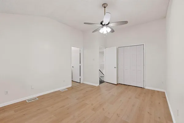 a view of an empty room with a fan