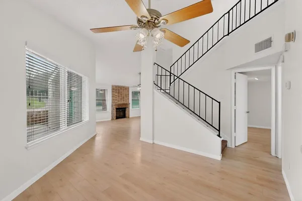 a view of an entryway with wooden floor and a ceiling fan