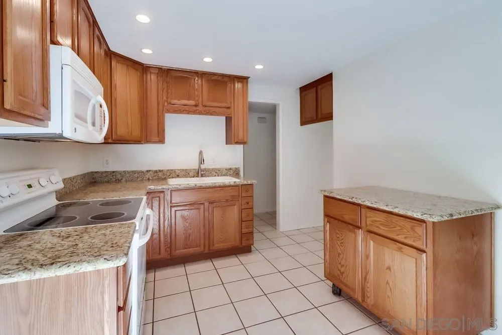 2157 Arnold Way, Unit 201 Alpine, CA 91901 - Photo 14 of 41 a kitchen with stainless steel appliances granite countertop a sink stove and cabinets