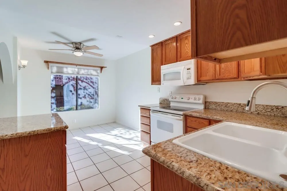 2157 Arnold Way, Unit 201 Alpine, CA 91901 - Photo 16 of 41 a kitchen with stainless steel appliances granite countertop a sink stove and refrigerator
